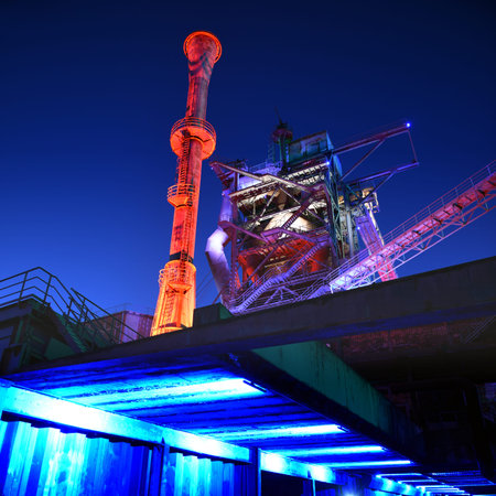 Industrial park Duisburg, Germany - steel industry blast furnace factory or plant abandoned old industrial architecture at night with colored lightsの写真素材