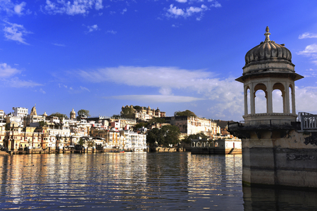 Gazebo at lake Pichola with panoramic cityscape and reflection in Udaipur, Rajasthan, Indiaの写真素材
