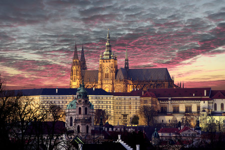 Panoramic view To Hradschin Castle, St. Vitus Cathedral And Charles Bridge In Prague, Czech Republic during sunset with dramatic skyの写真素材