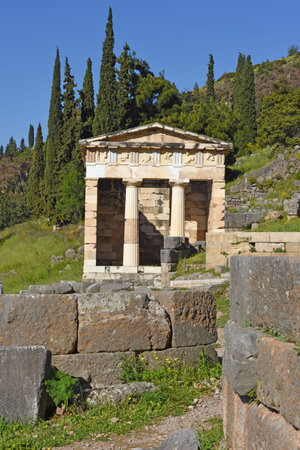 View to the Athenian treasury at the ancient oracle archaeological Delphi site, Greece