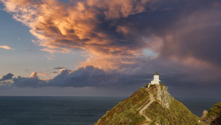 panoramic view to the Nugget Point Lighthouse during sunset, located in the Catlins area on the Southern Island Coast, Otago regionの写真素材