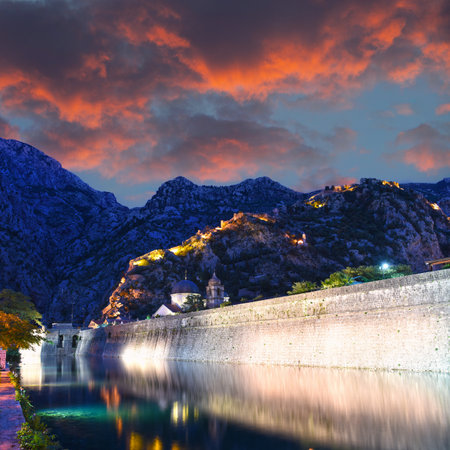 Illuminated Old fortress of Kotor, Montenegro at night. Tower and wall, mountain at the background. Fortress wall at the backgroundの写真素材