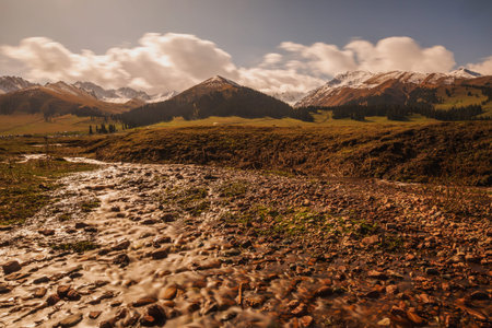 Landscape of mountains and river at sunset in Kyrgyzstan