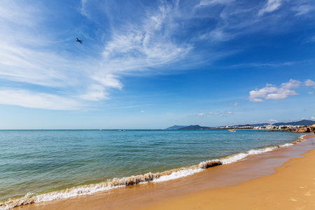 beach and tropical sea under blue sky with white clouds, Thailandの写真素材