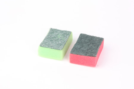 Two red and green sponges on white background