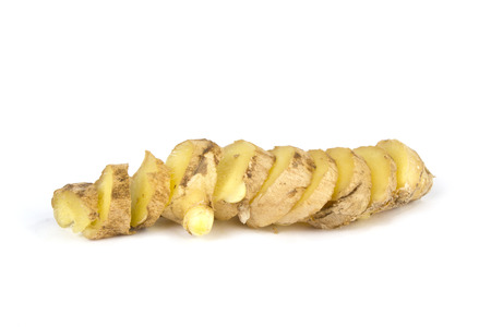 Sliced up ginger on white bakcgroundの写真素材