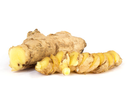 Sliced up ginger on white bakcground