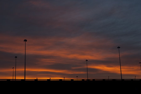 Sunrise behind a bridge showing deep red coloursの写真素材