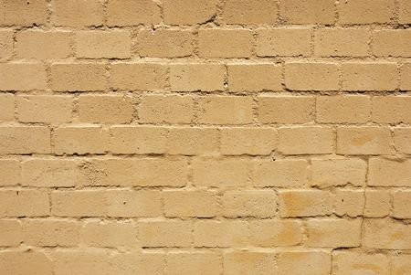 Texture shot of surfae of a brick wall semi covered with paintの写真素材