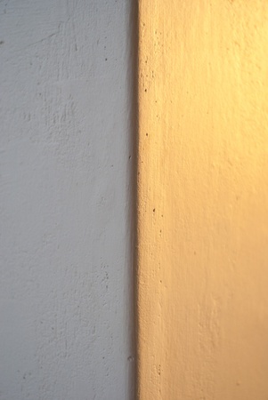 Texture shot of the surface of a wall, spilt in half vertically by light and shadow detailsの写真素材