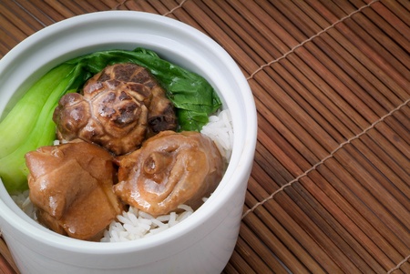 Chicken with rice and vegetables in backgroundの写真素材