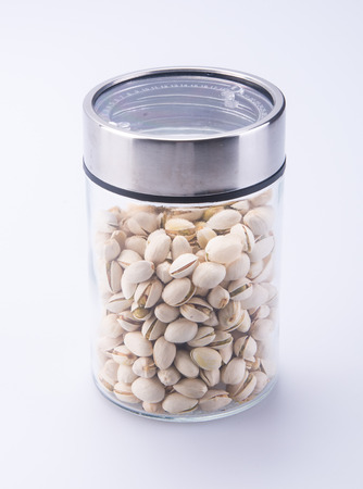 nuts. pistachios in the backgroundの写真素材