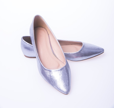 Silver colour fashion woman shoes on white backgroundの写真素材