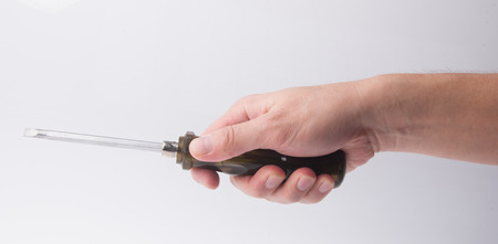 screwdriver in hand on the backgroundの写真素材
