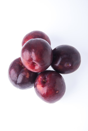 Ripe plum fruit on the white backgroundの写真素材