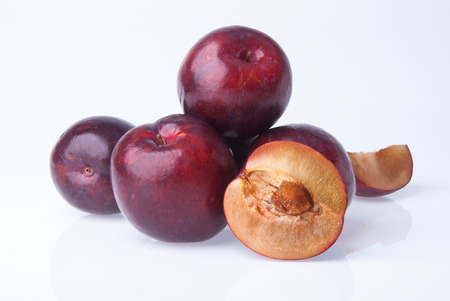 Ripe plum fruit on the white backgroundの写真素材