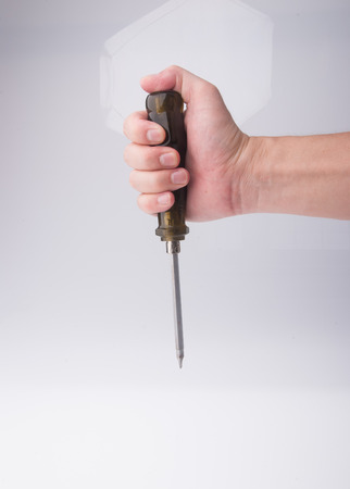 screwdriver in hand on the white backgroundの写真素材