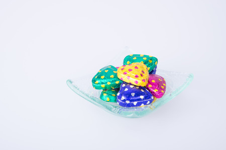 Chocolate or Colorful heart shape chocolate on a backgroundの写真素材