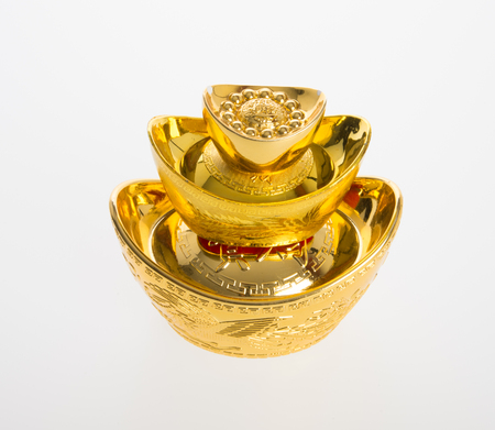 Gold or Chinese gold ingot mean symbols of wealth and prosperity on a backgroundの写真素材