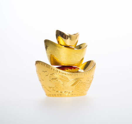 Gold or Chinese gold ingot mean symbols of wealth and prosperity on a backgroundの写真素材