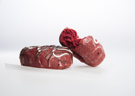 Donut with missing bite on a grey backgroundの写真素材