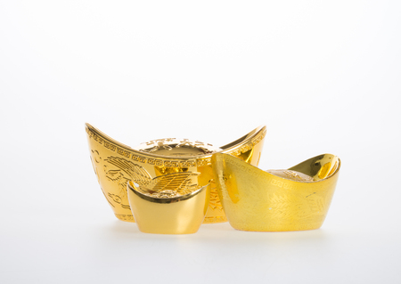 Gold or Chinese gold ingot mean symbols of wealth and prosperity on a backgroundの写真素材