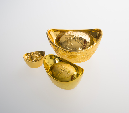 Gold or Chinese gold ingot mean symbols of wealth and prosperity on a backgroundの写真素材