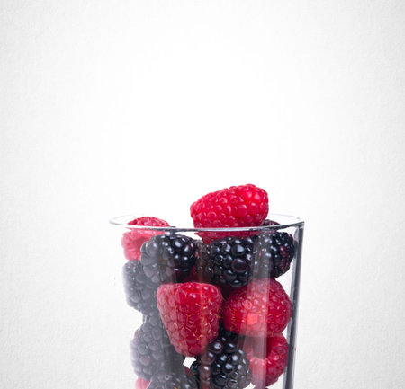raspberry and blackberries on white isolated background