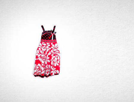 dress or dress for kids in red color on a backgroundの写真素材