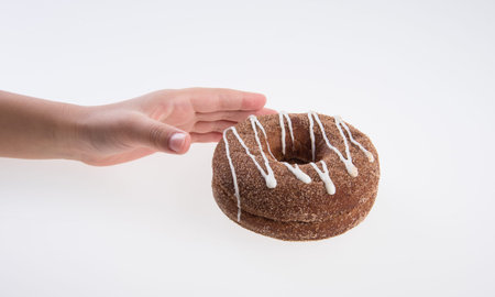 Donut or Donuts with hand on a background new