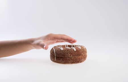 Donut or Donuts with hand on a background newの写真素材