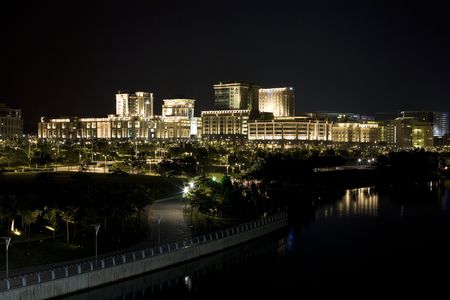 A night shot of brightly lit cluster of buildingsの写真素材