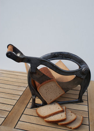 Front view of a nostalgic bread slicer with cutting bread