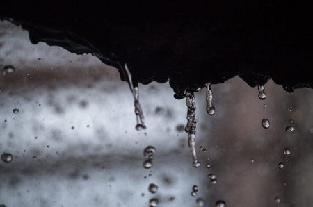 Falling drops of water on a rock