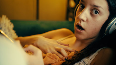 Teen Girl Stunned by Shocking News on Her Phoneの写真素材