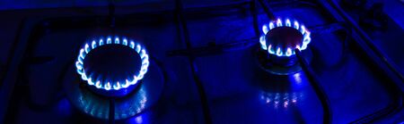 Panoramic view of an old gas stove destroyed tourist-powered gas cylinder with a background of blue tintの写真素材