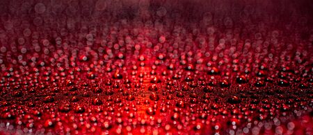 Panoramic dew view on red metallic surface with shallow depth of field for a rich bokeh effectの写真素材
