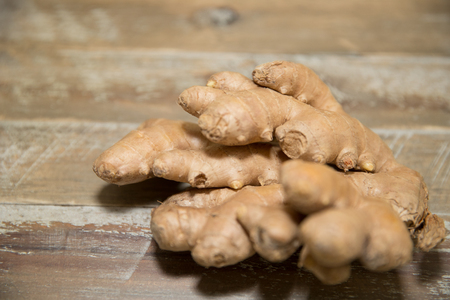 Fresh ginger root on the wooden tableの写真素材