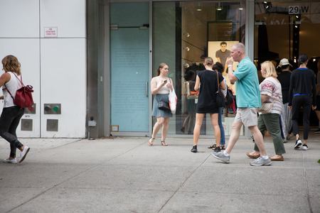 New York - June 2, 2018: A view down a busy avenue street, People walk on busy streetsのeditorial素材