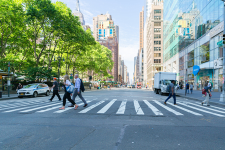 New York - June 2, 2018: A view down a busy avenue street, People walk on busy streetsのeditorial素材