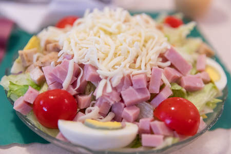 Closeup of ham salad on top of a lettuce leaf on a plateの写真素材