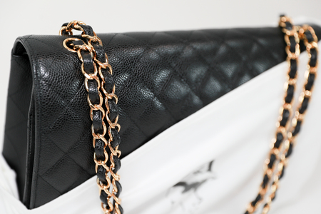 Philadelphia, Pennsylvania, USA, August 10, 2018: Photo of black Chanel handbag with Chanel dust bag brand Editorial on white background.のeditorial素材