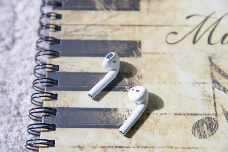 Lawrence Township New Jersey, April 1, 2019: Apple AirPods wireless Bluetooth headphones and charging case for Apple iPhone. New Apple Earpods Airpods in box. - Imageのeditorial素材