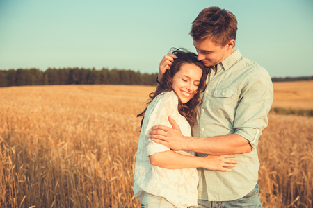 Young couple in love outdoor.Stunning sensual outdoor portrait of young stylish fashion couple posing in summer in fieldの写真素材