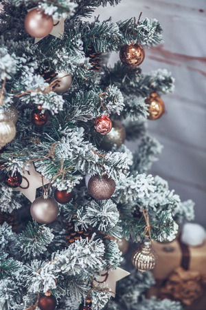 Christmas and New Year Tree decorated close up. Christmas present on white wooden background in vintage styleの写真素材