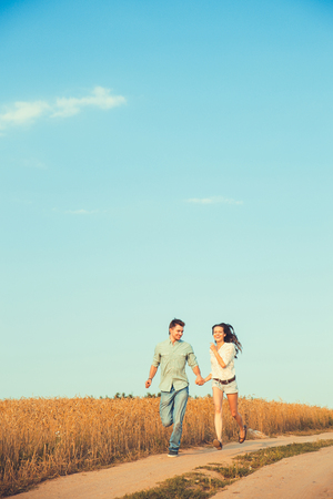 Young couple in love outdoor.Stunning sensual outdoor portrait of young stylish fashion couple posing in summer in fieldの写真素材