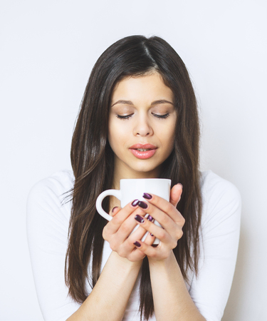 young pretty woman drinking coffee or tea. Relaxing girl. Woman drinking coffee in the morning at home lifestyle.の写真素材