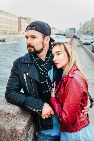 Stylish couple in city . Beautiful couple in love hugging and kissingの写真素材