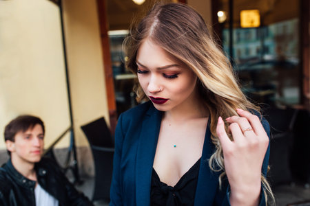 stylish hipster couple in cafe outdoor. portrait of sexy couple in cityの写真素材