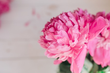 Bouquet of pink peonies on a white wooden table. Gift Valentine's Day.の写真素材